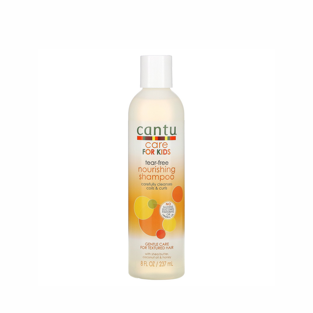 Bottle of CANTU Care for Kids Tear Free Nourishing Shampoo, 237ml - For Curly Hair, surrounded by natural ingredients shea butter, coconut oil, and honey.