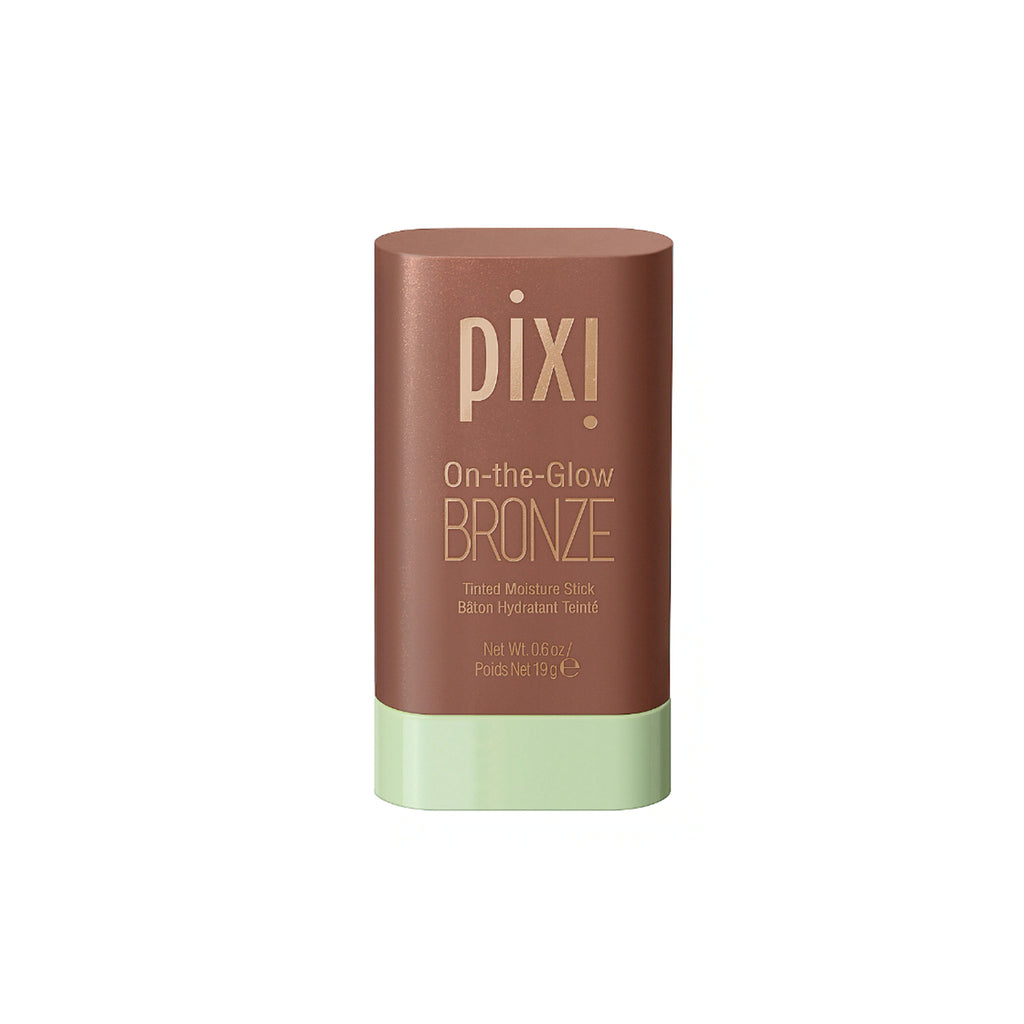A hand holding the Pixi On-the-Glow Bronze Tinted Moisture Stick and Blusher